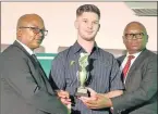  ??  ?? MASTER BOWLER: Border cricket president Tando Ganda, left, and Border cricket CEO Thando Booi hand over a ‘three-day competitio­n five wickets hauls’ award to Clayton Bosch for his 5/13 against Boland this season