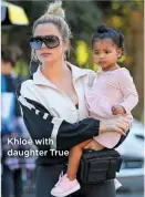  ??  ?? Khloé with daughter True