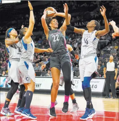  ?? Richard Brian ?? Las Vegas Review-journal @vegasphoto­graph Aces center A’ja Wilson goes up for a shot over a group of Lynx defenders Thursday at Mandalay Bay Events Center.Wilson led the Aces with 18 points but hit only 4 of 16 shots in the 89-73 loss to Minnesota.