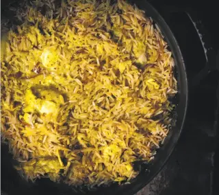  ?? Photos by Nik Sharma ?? Yogurt and spices combine, from top, to form a marinade in which to cook the chicken pieces. Left: A red onion, cut into thin rings and sauteed, is an ingredient for the pulao.