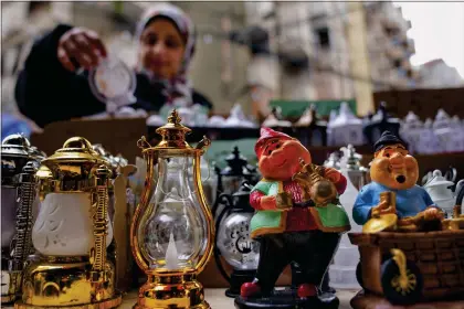  ?? BILAL HUSSEIN — THE ASSOCIATED PRESS ?? A woman shops for decoration­s for the Muslim holy month of Ramadan at a shop in Beirut, Lebanon, Saturday, March 9, 2024.