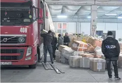  ?? EPA ?? Policemen check merchandis­e during the operation against the Chinese mafia called ‘China truck’ in Prato, Italy, on Thursday.