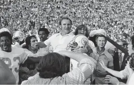  ?? FILE ?? Miami Dolphins coach Don Shula, center, is carried off the field after his team won the Super Bowl game over the Washington Redskins in Los Angeles on Jan. 14, 1973. It’s quite likely no other Miami team will ever live up to that perfect ’72 Dolphins team. That team has almost taken a larger-than-life meaning in the hearts and minds of sports fans.