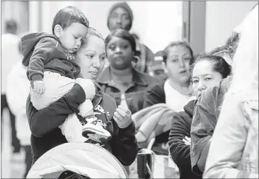  ?? LM OTERO/ASSOCIATED PRESS FILE PHOTO ?? Residents wait to sign up for insurance at Parkland Hospital in Dallas, where property owners paid more than $467 million in taxes last year to Parkland Health and Hospital System to provide medical care to the poor and uninsured.