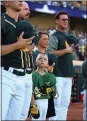  ??  ?? August Wold, 8, stands with the A’s during Saurday’s playing of the the national anthem before the game against the Texas Rangers.