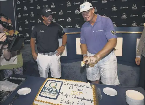  ??  ?? 0 Phil Mickelson and Ernie Els celebrate their 100th major championsh­ip at Quail Hollow.