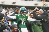  ?? Adam Hunger / Associated Press ?? Jets wide receiver Robby Anderson (11) celebrates with fans after scoring a touchdown during the second half of Sunday’s win over the Oakland Raiders.