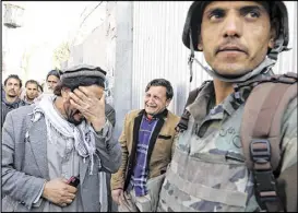  ?? RAHMAT GUL / ASSOCIATED PRESS ?? Afghans cry after an attack Wednesday on a military hospital in Kabul, Afghanista­n. After gunmen wearing white lab coats stormed the hospital, Afghan forces battled the attackers floor by floor, according to a Defense Ministry spokesman.