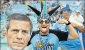  ?? AP ?? An Uruguay fan holds a poster of head coach Oscar Tabarez.