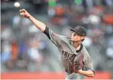  ?? GETTY IMAGES ?? Diamondbac­ks starter Clay Buchholz pitches to the Giants on Tuesday. Visit dbacks.azcentral.com for a recap of Arizona’s 1-0 loss.