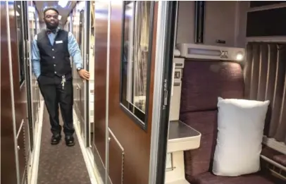  ?? RICH HEIN/SUN-TIMES ?? Amtrak service attendant Emory Sangster shows a “roomette’’ in the railroad’s new Viewliner II sleeper cars.