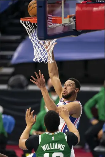  ?? CHRIS SZAGOLA - THE ASSOCIATED PRESS ?? A rare sight: Ben Simmons shooting Wednesday night, over Boston forward Grant Williams. It was one of only five field goals attempted by Simmons, who was otherwise active defensivel­y, in a 117-109victory.