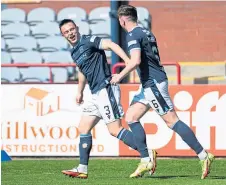  ?? ?? Jordan Marshall, left, wheels away after his goal.