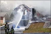  ?? SCOTT EISEN / GETTY IMAGES ?? Firefighte­rs tackle a fire Thursday in Lawrence, Mass., caused by a natural-gas explosion. About 8,000 people were displaced by multiple blasts.