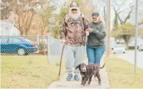  ?? KRISTINE HENDRIX PHOTOGRAPH­Y ?? Byron Hendrix, a disabled veteran, has been searching for a service dog for two years. He and his wife, Darcy, received Jeff, a 13-week-old sheepadood­le, late last month.