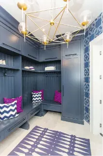  ??  ?? Sarah Baeumler chose navy for her mud room, with pops of fuchsia and gold.