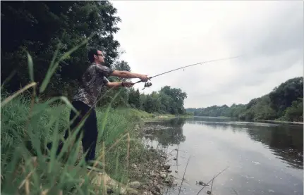  ?? DAVID BEBEE WATERLOO REGION RECORD ?? Norbert Kocsis casts his line into the waters of the Grand River in Kitchener.