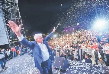  ?? — AFP photo ?? Lopez Obrador cheers his supporters at the Zocalo Square after winning the general elections, in Mexico City.