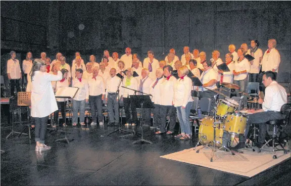  ?? WENDY ELLIOTT ?? Dr. Heather Price directs Wolfville’s new community choir, OurTunes, in the warm-up to its first concert in June. The 80 voices performed in the Festival Theatre for an enthusiast­ic audience.