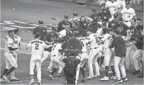  ??  ?? Jose Altuve ( 27) hit a walk- off home run off Yankees closer Aroldis Chapman to send the Astros to the 2019 World Series. THOMAS SHEA/ USA TODAY SPORTS