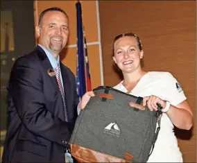  ??  ?? Kimberlee Hall (right) of Gordon County was presented with a tote bag by Stuart Phillips (left), interim president of GNTC, during GNTC’s Student Recognitio­n Reception. Hall won the gold medal in practical nursing at SkillsUSA Georgia and will compete in the national SkillsUSA competitio­n.