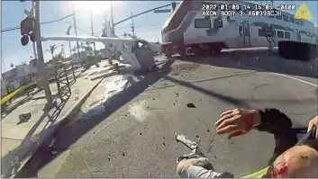  ?? LOS ANGELES POLICE DEPARTMENT ?? A train heads for a wrecked plane just after Los Angeles police pulled the pilot to safety on Sunday in an image from an officer’s body camera.