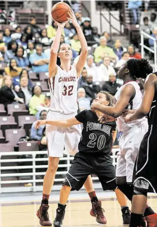  ?? Jerry Baker ?? When Cypress Woods’ 6-9 center Nancy Mulkey, left, extends herself for a jump shot, there’s little a defense can do to stop her. She’ll try to help the Wildcats repeat as 6A state champions.