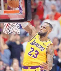  ?? CRAIG MITCHELLDY­ER/ ASSOCIATED PRESS ?? Los Angeles’ LeBron James dunks during the first half of the Lakers’ loss to the Trail Blazers Thursday in the season opener for both teams.
