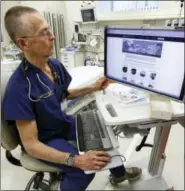  ?? THE ASSOCIATED PRESS ?? Dr. Garen Wintemute, an emergency room physician at the University of California, Davis, Medical Center, shows the website of the Bureau of Alcohol, Tobacco and Firearms, on a computer in the hospital in Sacramento, Calif.