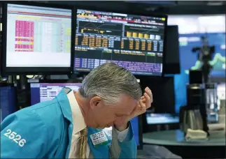  ?? MARK LENNIHAN — THE ASSOCIATED PRESS ?? A trader reacts after trading was halted March 18, 2020, at the New York Stock Exchange. On March 23, 2020, the S&P 500fell 2.9%. In all, the index dropped nearly 34% in about a month, wiping out three years’ worth of gains for the market.