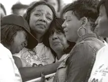  ?? Melissa Phillip / Houston Chronicle ?? Stacey Riddle, second from left, is consoled at a memorial honoring her daughters, Jade, 17, and Brianna, 19, who died in a car crash in March 2016.