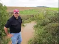  ?? JOHN FLESHER — THE ASSOCIATED PRESS ?? In this photo, Brent Peterson, who promotes runoff prevention in eastern Wisconsin’s Lower Fox River watershed, stands beside a creek in Brown County, Wis. The Fox River empties into the algae-plagued Green Bay, which contains less than 2percent of...