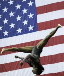  ?? Associated Press ?? Simone Biles posted the top score on the balance beam, above, floor and vault at the U. S. women’s gymnastics championsh­ips Sunday in Kansas City, Mo.