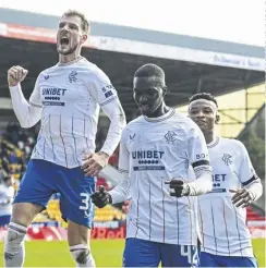  ?? ?? James Tavernier, right, scores from the spot to make it 3-0 to Rangers. Above, Mohamed Diomande celebrates his opener