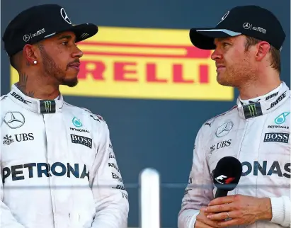  ?? GETTY IMAGES/AFP ?? Face off: Hamilton and Rosberg look frosty on the podium in Sochi last year
