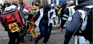  ?? AFP ?? A protester is carried into an ambulance during a demonstrat­ion in Paris. —