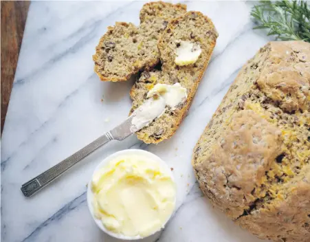  ??  ?? Dense, savoury soda bread is strewn with wheat berries, cheese, nuts and rosemary.