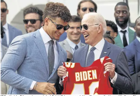  ?? reuters ?? US President Joe Biden reacts as quarterbac­k Patrick Mahomes presents him with a personalis­ed jersey of the Kansas City Chiefs.