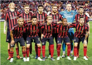  ?? CURTIS COMPTON / CCOMPTON@AJC.COM ?? Atlanta United players pose for a team photo before taking the field to play Herediano in the CONCACAF Champions League match last week at Kennesaw State. Front (from left): Josef Martinez, Pity Martinez, Ezequiel Barco, Darlington Nagbe and Eric Remedi. Back (from left): Brek Shea, Julian Gressel, Miles Robinson, Leandro Gonzalez Pirez, goalkeeper Brad Guzan and Michael Parkhurst. United won the match and advanced to the tournament’s quarterfin­als.