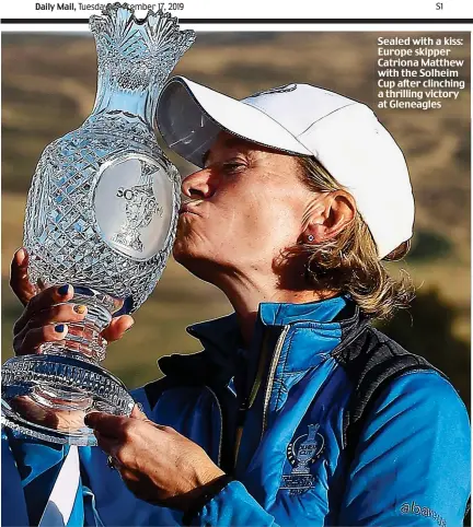  ??  ?? Sealed with a kiss: Europe skipper Catriona Matthew with the Solheim Cup after clinching a thrilling victory at Gleneagles