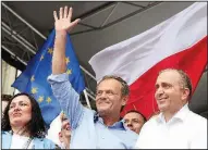  ?? AP/CZAREK SOKOLOWSKI ?? European Union Council President and former Poland Prime Minister Donald Tusk (center) leads a march Saturday in Warsaw celebratin­g Poland’s 15 years in the European Union.