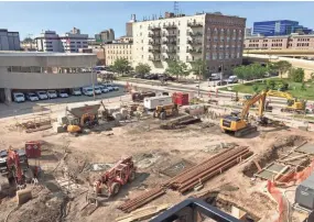  ?? / MILWAUKEE JOURNAL SENTINEL ?? A parking structure under constructi­on near the Pritzlaff buildings will provide spaces for apartment residents and office workers when it’s completed in November.