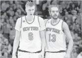  ?? CHRISTIAN PETERSEN/GETTY ?? Kristaps Porzingis (6) of the Knicks is congratula­ted by Joakim Noah after scoring against the Suns in 2016.