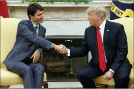  ?? EVAN VUCCI — THE ASSOCIATED PRESS FILE ?? In this file photo, President Donald Trump shakes hands with Canadian Prime Minister Justin Trudeau in the Oval Office of the White House. When Trump visits this week there’s speculatio­n he could walk out of meetings with allies furious over his...