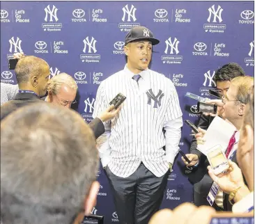  ?? WILLIE J. ALLEN JR. / AP ?? New Yankees slugger Giancarlo Stanton holds court Monday with media members during MLB’s winter meetings in Florida. “They’re winners,” Stanton said of his new team while calling his former club a “circus.”