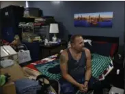  ??  ?? Iraq war veteran Vernon Poling, 44, who was homeless for seven months, rests in his apartment made out of shipping containers in Midway City, Calif. Poling, who had been medically discharged from the Army in 2014, was the last of 15homeless veterans to...