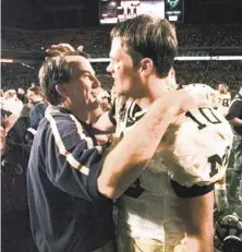  ?? Associated Press 2000 ?? Head coach Lloyd Carr congratula­ted Tom Brady after Michigan beat Alabama in overtime in the 2000 Orange Bowl.