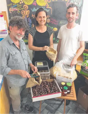  ??  ?? ORGANIC FARE: Volunteers Peter Reay (left), Beth Shorter and Alex Daly at work at Community Foods, which aims to make it easier to make healthy, ethical choices.