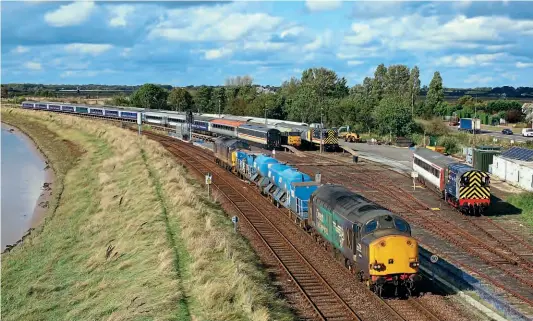  ?? JAMIE SQUIBBS ?? Shades of the old days at Great Yarmouth on October 4, with three locos, two shunters and busy carriage sidings – although the circumstan­ces today are very different. DRS Type 3s Nos. 37059 and 37425 were ‘top and tailing’ the 3S01/09.22 Stowmarket circular RHTT train, while Nos. 08762 and 08870 shunt Eastern Rail Services’ stock and Type 2 No. 31452 lurks amongst the coaches.