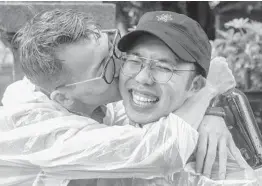  ?? CARL COURT/GETTY ?? Taiwanese men celebrate after the vote to legalize same-sex marriage was announced. Thousands of gay rights supporters were outside the parliament building in Taipei.